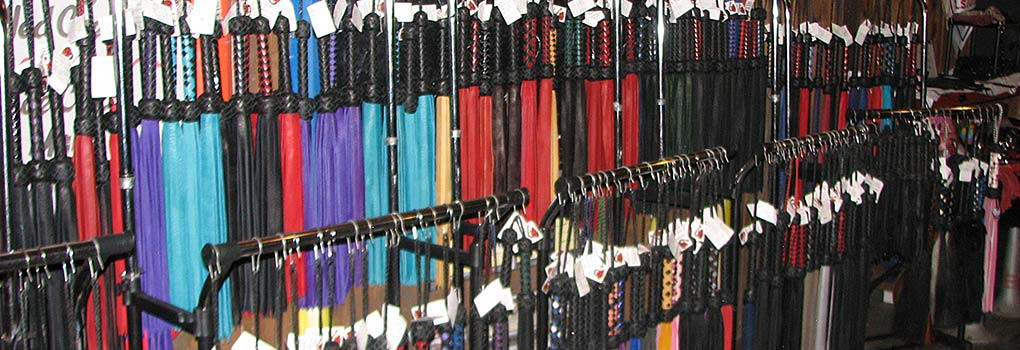 a rack of floggers for sale in lots of styles and colors
