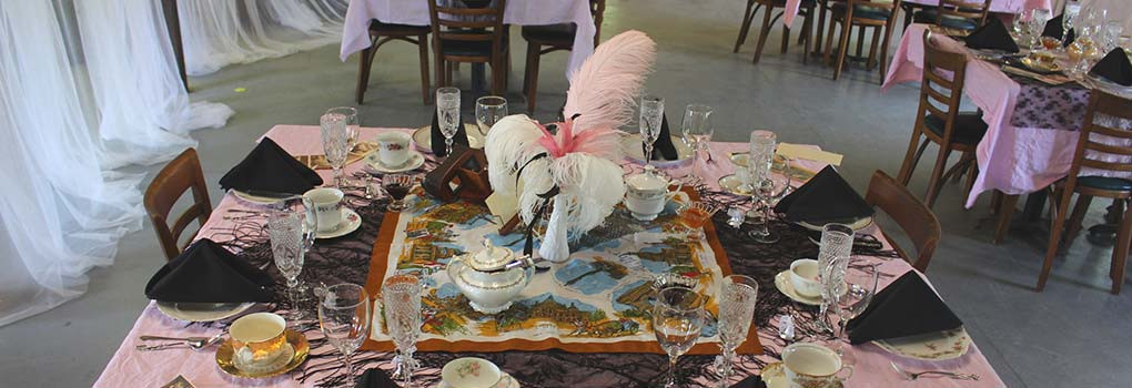 A table, elaborately set, ready for tea to be served