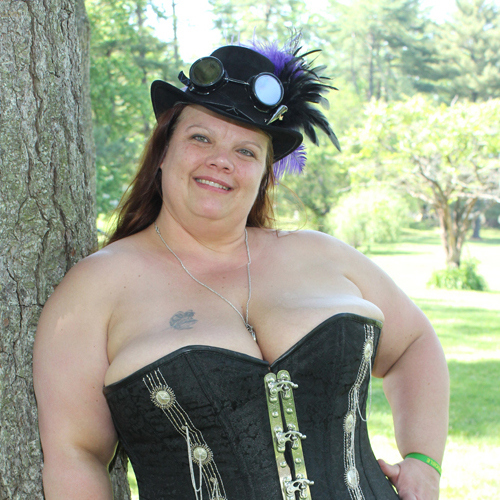 smiling woman in corset with fancy hat